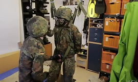 Two soldiers in German Flecktarn in gas masks wanking
