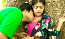 Γλυκό δίνοντας ένα φιλί ινδικό κολέγιο κορίτσι υπαίθριο ρομάντζο