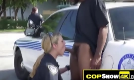 Public threeway with a black criminal and two busty MILF officers.