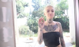 Short-haired vixen with lots of tattoos fucks her girlfriend